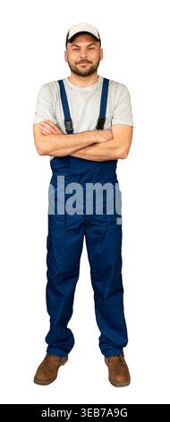 Das vollflächige Porträt eines Technikers im Overall mit gekreuzten Armen. Stockfoto