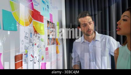 Prüfen von zwei in blau-oben, mint-oben, Zeigen auf die Planungswand in Besprechung, Notizen, Diagramm, Kopierraum Stockfoto