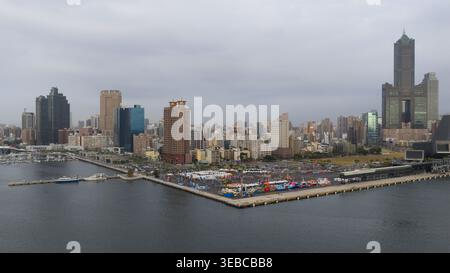 Yicheng Village, Taiwan - 25. Februar 2026: Aus der Vogelperspektive auf den Sky Tower von 85 und die Skyline entlang des Hafens mit einem Pier und farbenfrohen Eventzelten un Stockfoto