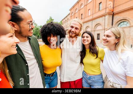 Glückliche junge Freunde, die zusammen in der Stadt stehen Stockfoto