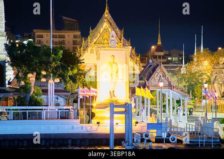 BANGKOK, THAILAND - 01. März 2025: Öffentliches Denkmal für den verehrten thailändischen König Rama IX. Mit traditioneller Architektur und patriotischer Atmosphäre nach Einbruch der Dunkelheit. Hallo Stockfoto