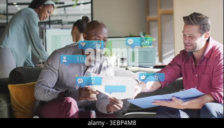 Wir reden über Umschlag und blauen Ordner, zwei Männer auf der Couch in Grau, rote Hemden im Büro, Benachrichtigungen Stockfoto