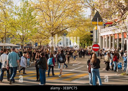 Zürich, Schweiz, 20. April 2026. Eine große Menschenmenge und Festivalbesucher spazieren entlang der von Bäumen gesäumten Utoquai-Promenade in der Nähe von Bellevue während der t Stockfoto