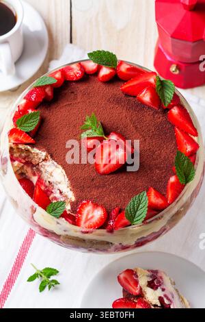 Erdbeer-Tiramisu-Dessert mit Cremeschichten und Minze in Glasschale Stockfoto