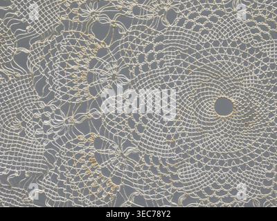 Serviette, Serviette, Geschenk, Spitze, Spitzenserviette, weiße, runde, große dreieckige Zähne am Rand, konzentrische und radiale geometrische Ornamente, 20. Jahrhundert, Polen, Stoff, Spitze, Durchmesser 33 cm, Ein zartes, gehäkeltes Spitzengewebe mit einem komplizierten Kreis- und Blumenmuster in cremefarbenen und cremefarbenen Tönen auf einem mittelgrauen Hintergrund, das eine Gruppe von durchbrochenen Schlaufen, gewellten Kanten und ausstrahlenden konzentrischen Ringen mit ein paar größeren runden Löchern und mehreren kleineren, maschenartigen Bereichen zeigt, die durch feine Fäden gebildet werden. Stockfoto