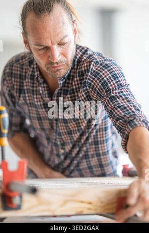 Zimmermann arbeitet an Holzbrettern in der Werkstatt Stockfoto