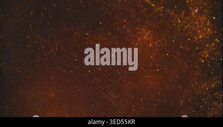 Schimmernde Unschärfe. Leuchtende Textur. Braun-Orange, funkelnder Emulsionsstrahl. Farbtinte Flare Partikel, die sich im abstrakten Hintergrund bewegen. Stockfoto