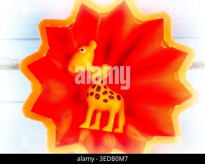 Gelbe Giraffe in einer orangen Pyramidenlandschaft Stockfoto