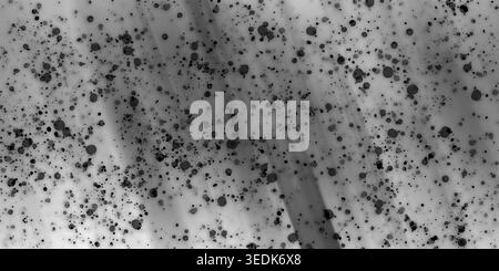 Ein abstrakter künstlerischer Hintergrund mit verstreuten schwarzen Tintenspritzern und Punkten über einem weichen, monochromatischen Grauverlauf mit subtilen Lichtstreifen. Stockfoto