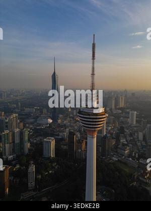 Aus der Vogelperspektive auf den Menara Kuala Lumpur Turm und den Merdeka 118 Wolkenkratzer, der während der goldenen Stunde in Kuala Lumpur, Federal Ter, über der städtischen Skyline aufragt Stockfoto
