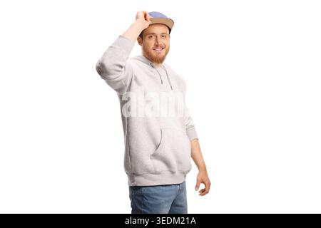 Junger Mann, der einen Hoodie und eine Mütze auf weißem Hintergrund trägt Stockfoto