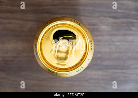 Details der goldenen Dose des generischen Lagerbiers auf dem Tisch, nachdem sie geöffnet wurde Stockfoto