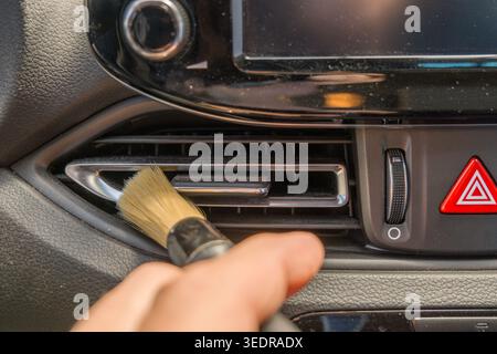 Detaillierte Reinigung des Innenraums. Hand halten und weiche Bürste verwenden Stockfoto