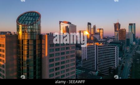 Warschau, Polen - 07. März 2026: Aus der Vogelperspektive auf die moderne Skyline mit dem Westin Hotel und Glashochhäusern, die das goldene Sonnenuntergangslicht reflektieren. Stockfoto