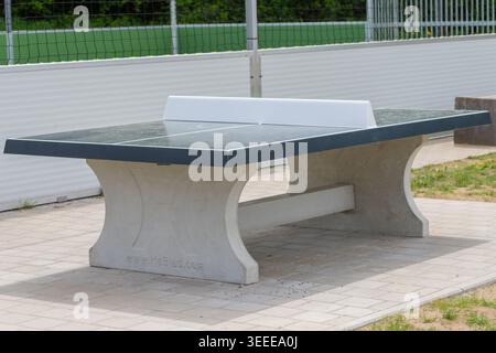 Strapazierfähiger Tischtennistisch aus Beton, der in einem Erholungsbereich im Freien steht Stockfoto