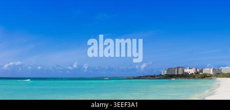 Panoramablick auf Eagle Beach in Aruba mit türkisfarbenem karibischem Wasser und weißer Sandküste mit tropischer Skyline unter einem klaren blau Stockfoto