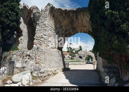 Antike römische Ruinen des Amphitheaters Cimiez mit massivem Steinbogen in Nizza. Historische archäologische Stätte der französischen Riviera mit verwitterten Kalksteinmauern Stockfoto