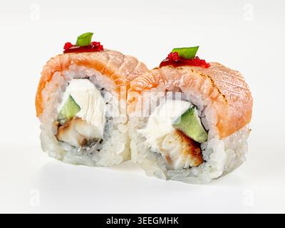 Eine Nahaufnahme von zwei japanischen Uramaki-Sushi-Brötchen mit gebratenem Lachs, Aal, Frischkäse, Gurke. Garniert mit rotem Tobiko-Reh. Saubere, minimalistische Komposition Stockfoto