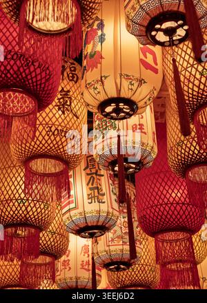 Blick hinauf durch eine dichte Ansammlung von beleuchteten roten und goldenen chinesischen Laternen, die draußen hängen, Kuala Lumpur, Malaysia Stockfoto