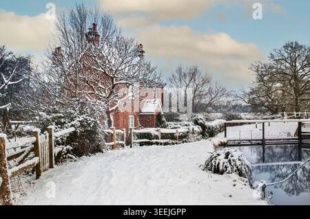 SNOW RIVER WEY Winter über Papercourt Lock und das schneebedeckte Schleusenhäuschen auf dem Fluss Wey Schleusenpfad nach dem jüngsten Schneefall Surrey England Großbritannien Stockfoto