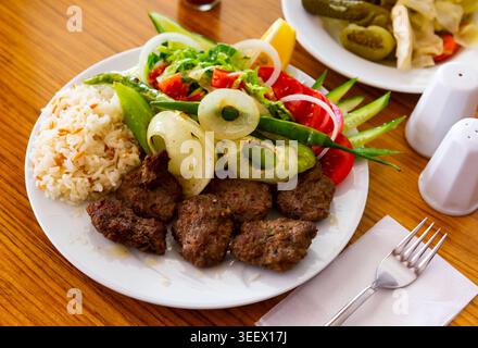 Türkische Kofte auf mangal mit Gemüse und Reis zubereitet Stockfoto