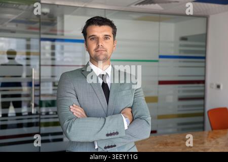 Erwachsener kaukasischer Geschäftsmann posiert im Büro Stockfoto