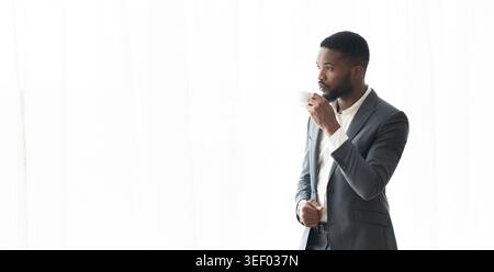 Nachdenklich Afrikanische amerikanische Geschäftsmann genießen Cityview aus dem Fenster im Büro Stockfoto