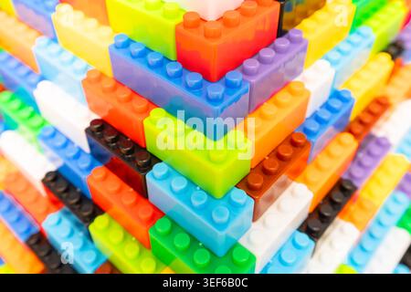 Bunte Spielzeugbausteine aus Kunststoff, die in einer Pyramidenstruktur zusammengestapelt sind Stockfoto