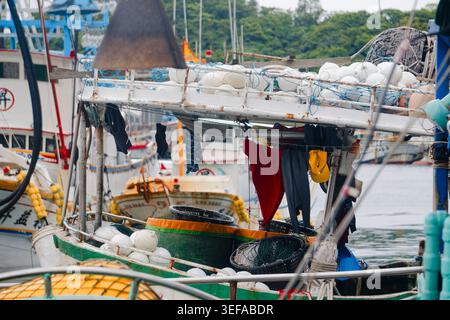 Yilan, Taiwan - 31. März 2025: Wäschetrocknung auf einem angedockten Fischerboot in Nanfangao, das das Leben von Wanderfischern auf taiwanesischen Schiffen widerspiegelt. Stockfoto