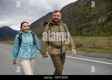 Glückliches Wanderpaar, das auf der Mountain Road spaziert Stockfoto