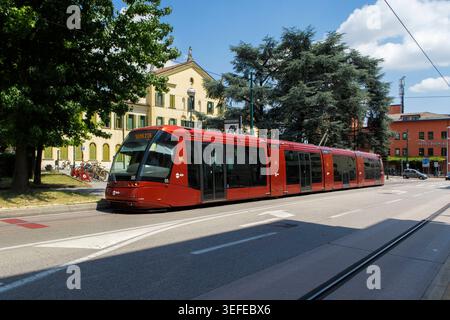 Moderne rote Straßenbahn fährt an einem sonnigen Tag auf der Straße in Mestre in der Nähe von Venedig, Italien Stockfoto