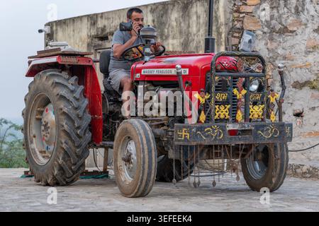 Mann auf Massey-Ferguson-Traktor telefoniert Stockfoto