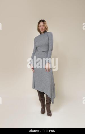 Einfarbiges graues Strickset mit Rollkragen und asymmetrischem Midirock – elegante Damenkollektion für den Herbst Stockfoto