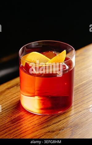 Ein klassischer negroni-Cocktail mit Orangengarnitur Stockfoto