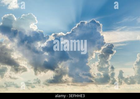 Eine atemberaubende Wolkendecke erfüllt den Himmel, während die Sonne untergeht, und schafft eine dramatische und malerische Kulisse für abendliche Momente. Stockfoto