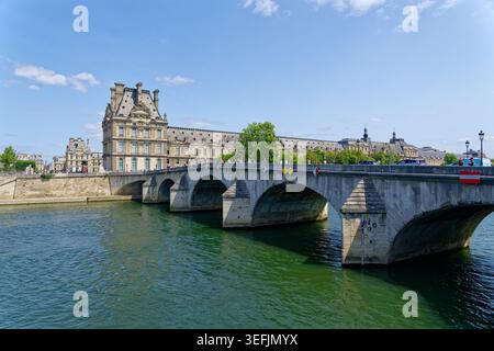Paris, Frankreich. 5. August 2025: Eine klassische Steinbrücke überspannt die seine in der Nähe von historischen Gebäuden am Wasser und Sehenswürdigkeiten. Stockfoto