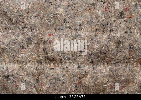 Nahtstruktur aus recyceltem Futterstoff für Polsterung, Isolierung, Schalldämmung, Matratzen und recycelte Materialien als Hintergrund Stockfoto