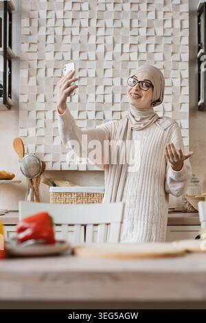 Frau filmt sich selbst in der Küche Stockfoto