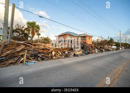 Hurrikanschäden in Florida. Müllhaufen auf der Straßenseite von zerstörten Häusern. Folgen von Naturkatastrophen Stockfoto