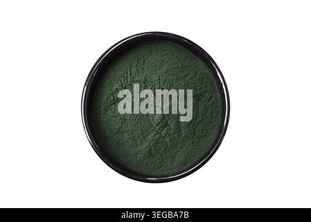 Lebensmittel, Gewürze, grüne Spirulina in Form von Pulver in einer schwarzen Schüssel auf dunklem Betonhintergrund Stockfoto