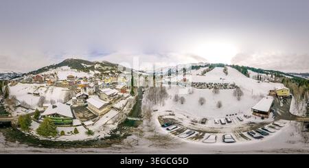 Aus der Vogelperspektive auf das UNESCO Biosphare Entlebuch mit dem verschneiten Dorf Soerenberg mit Berggipfeln und einem sich windenden Fluss in Soerenberg, Luzern, SWI Stockfoto