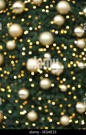 Festlicher weihnachtlicher Bokeh-Hintergrund mit goldenen Ornamenten und funkelnden Lichtern. Stockfoto