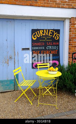 Gelber Tisch und Stühle mit Zitronen vor dem Fischgeschäft von Gurney, burnham Market, Nord-norfolk, england Stockfoto