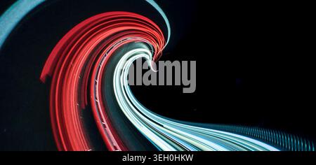 Abstrakte Lichtwelle mit rot-weißen Neonspuren auf Schwarz Stockfoto