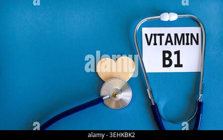 Vitamin B1-Symbol. Concept Words Vitamin B1 auf schöner weißer Karte. Holzherz und Stethoskop. Wunderschöner blauer Hintergrund. Medizinisches gesundes lifestyl Stockfoto