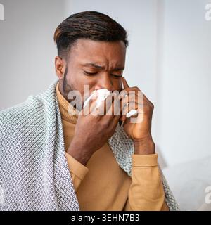Sick African American Man Blasen Nase am Telefon sprechen zu Hause Stockfoto