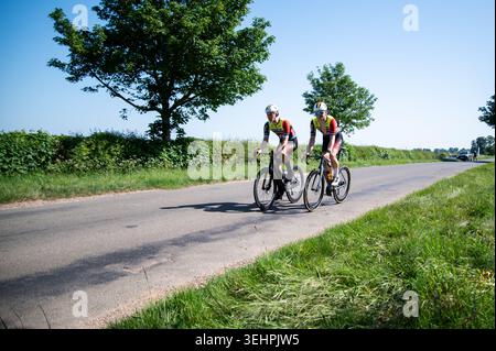 Grantham, Vereinigtes Königreich, 25. Mai 2026. Während das Land am heißesten Mai-Tag gebacken wird, nimmt das britische Radfeld am GA Bennett Road Race in der Landschaft außerhalb Granthams Teil. Zwei Schils-Dolticini-Fahrer nehmen auf dem Platz teil. Quelle: Joe Hudson/Alamy Live News Stockfoto