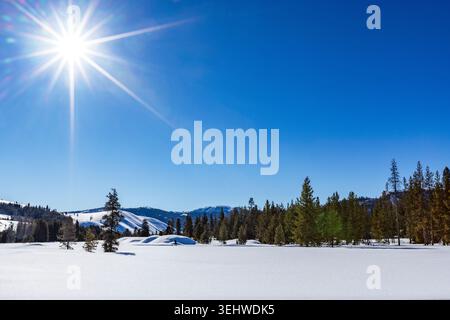 Die Sonne scheint über dem schneebedeckten Sun Valley Stockfoto