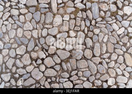 Pflastersteinpflaster Textur-Hintergrund mit Natursteinmuster Stockfoto