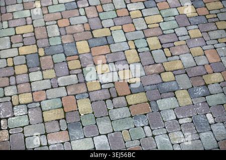 Bunte Pflastersteine. Bürgersteig Hintergrund. Cobblestone Textur Stockfoto